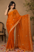 Burnt Orange Synthetic Chiffon Saree with Golden Leaf Embroidery & Floral Vine Border